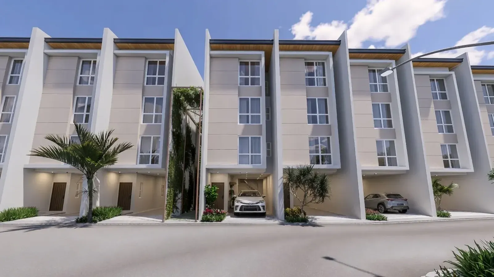 Four-storey townhouses at Pineglades Residences in Quezon City with carports and planted fronts